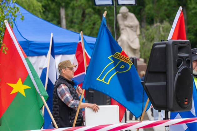 A flag of the pioneer organization of the GDR on 9 May, Victory Day, at the Soviet memorial in Treptower Park in Berlin Treptow In the background the figure of Motherland