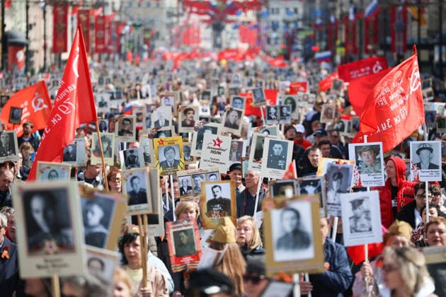 RUSSIA, ST PETERSBURG - MAY 9, 2026: People hold portraits of their relatives who fought in World War II as they take part in an Immortal Regiment event on Victory Day. Valentin Yegorshin TASS  92225673
