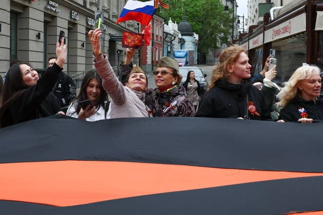 RUSSIA, MOSCOW - MAY 9, 2026: People unfurl a giant St George ribbon during a flash mob on Arbat Street on Victory Day. Mikhail Tereshchenko TASS  92239992