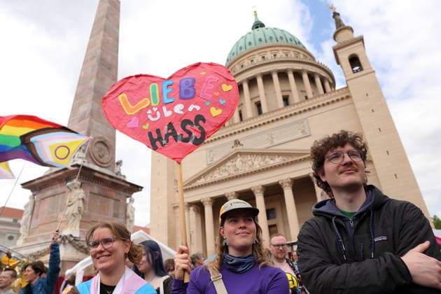 People stand with sign Love over hate on the Old Market during a demonstration for Christopher Street Day in Potsdam, May 9, 2026 CSD in Potsdam