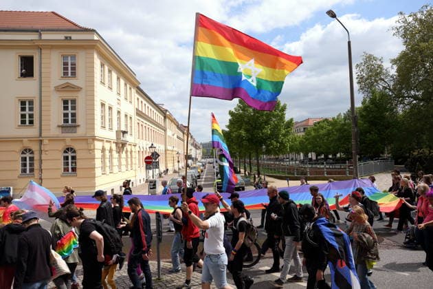 People walk with rainbow flags in Dortustraße during a demonstration for Christopher Street Day in Potsdam, May 9, 2026 CSD in Potsdam