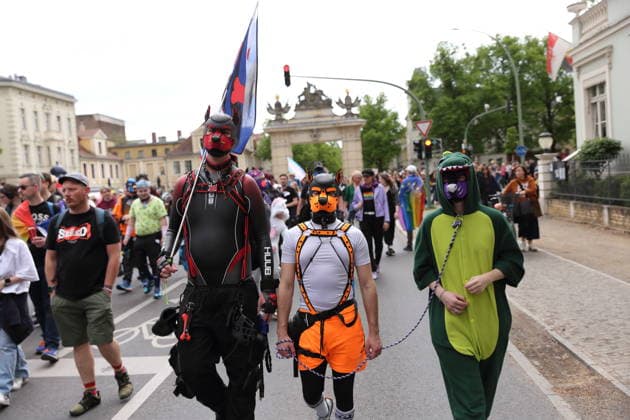 People with masks walk at the Jägertor during a demonstration for Christopher Street Day in Potsdam, May 9, 2026 CSD in Potsdam