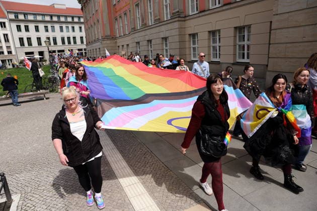People walk with a rainbow flag at the state parliament during a demonstration for Christopher Street Day in Potsdam, May 9, 2026 CSD in Potsdam