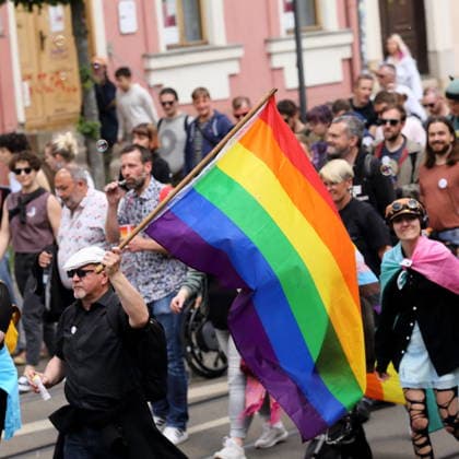 People walk with a rainbow flag in Charlottenstraße during a demonstration for Christopher Street Day in Potsdam, May 9, 2026 CSD in Potsdam
