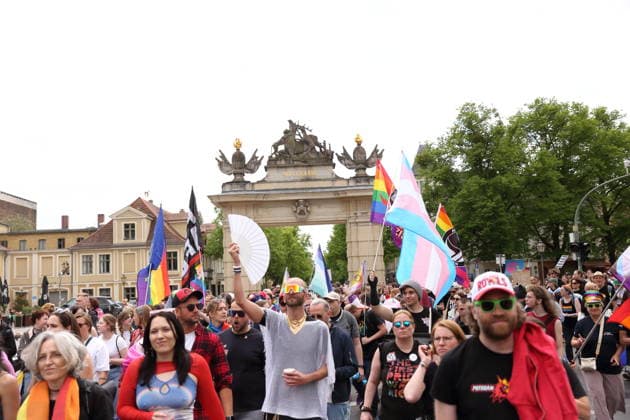 People walk with various flags at the Jägertor during a demonstration for Christopher Street Day in Potsdam, May 9, 2026 CSD in Potsdam