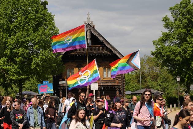 People walk with rainbow flags in the Russian colony Alexandrowka during a demonstration for Christopher Street Day in Potsdam, May 9, 2026 CSD in Potsdam