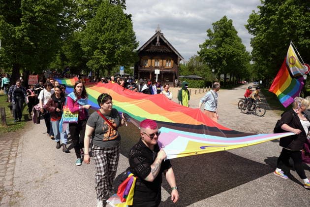 People walk with a rainbow flag in the Russian colony Alexandrowka during a demonstration for Christopher Street Day in Potsdam, May 9, 2026 CSD in Potsdam