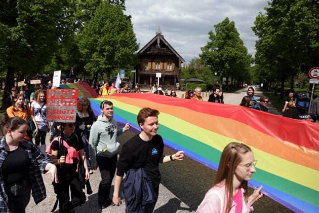 People walk with a rainbow flag in the Russian colony Alexandrowka during a demonstration for Christopher Street Day in Potsdam, May 9, 2026 CSD in Potsdam