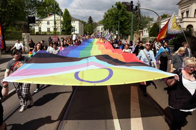 People walk with a rainbow flag in Friedrich Ebert Straße during a demonstration for Christopher Street Day in Potsdam, May 9, 2026 CSD in Potsdam