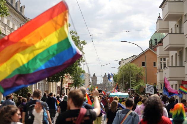 People walk with a rainbow flag in Friedrich Ebert Straße during a demonstration for Christopher Street Day in Potsdam, May 9, 2026 CSD in Potsdam