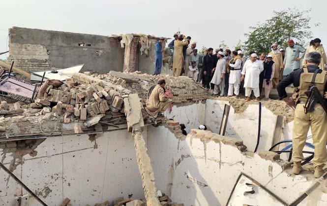 (260510) -- BANNU, May 10, 2026 -- People gather at the site of a suicide attack in Bannu district, Khyber Pakhtunkhwa province, Pakistan, May 10, 2026. At least 12 police personnel were killed and several others injured after a suicide bomber rammed an explosive-laden vehicle into a police installation in Pakistan s northwestern Khyber Pakhtunkhwa province, official sources said on Sunday. (Str Xinhua) (SpotNews) PAKISTAN-BANNU-POLICE INSTALLATION-SUICIDE ATTACK-AFTERMATH AhmadxKamal 