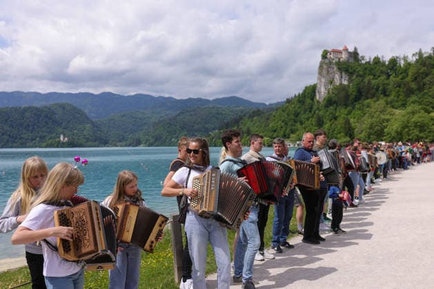 (260510) -- BLED, May 10, 2026 -- Participants play the accordion during the accordion weekend event at Lake Bled in Bled, Slovenia, May 10, 2026. This annual event brings together hundreds of participants for band performances, ensemble shows and an accordion procession. (Photo by Xinhua) SLOVENIA-BLED-ACCORDION WEEKEND ZeljkoxStevanic 