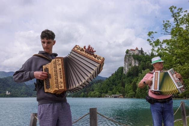(260510) -- BLED, May 10, 2026 -- Participants play the accordion during the accordion weekend event at Lake Bled in Bled, Slovenia, May 10, 2026. This annual event brings together hundreds of participants for band performances, ensemble shows and an accordion procession. (Photo by Xinhua) SLOVENIA-BLED-ACCORDION WEEKEND ZeljkoxStevanic 