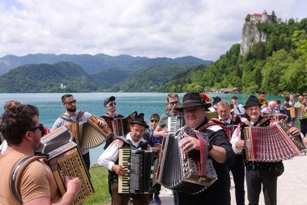 (260510) -- BLED, May 10, 2026 -- Participants play the accordion during the accordion weekend event at Lake Bled in Bled, Slovenia, May 10, 2026. This annual event brings together hundreds of participants for band performances, ensemble shows and an accordion procession. (Photo by Xinhua) SLOVENIA-BLED-ACCORDION WEEKEND ZeljkoxStevanic 