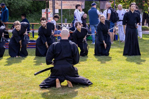Augsburg, Bavaria, Germany May 10, 2026: Participants in a Japanese martial arts demonstration practice with traditional swords in an open area. Traditional Japanese Spring Festival at the Augsburg Botanical Garden. The event is part of the garden™s 90th anniversary celebrations