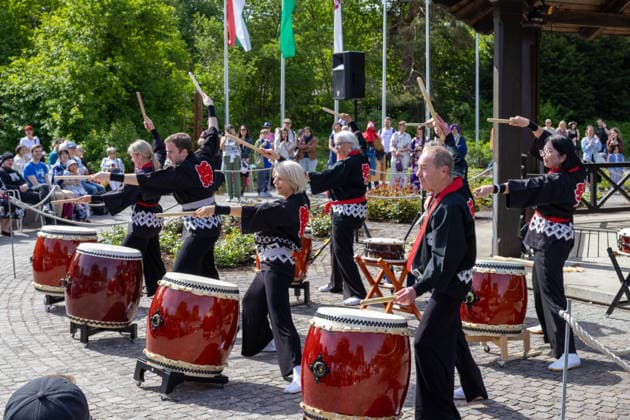 Augsburg, Bavaria, Germany May 10, 2026: Members of a Japanese taiko drumming group perform at an outdoor cultural event. Traditional drum rhythms and choreographed movements draw a large crowd. Traditional Japanese Spring Festival at the Augsburg Botanical Garden. The event is part of the garden™s 90th anniversary celebrations