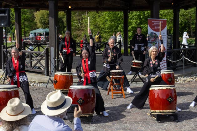 Augsburg, Bavaria, Germany May 10, 2026: Members of a Japanese taiko drumming group perform at an outdoor cultural event. Traditional drum rhythms and choreographed movements draw a large crowd. Traditional Japanese Spring Festival at the Augsburg Botanical Garden. The event is part of the garden™s 90th anniversary celebrations