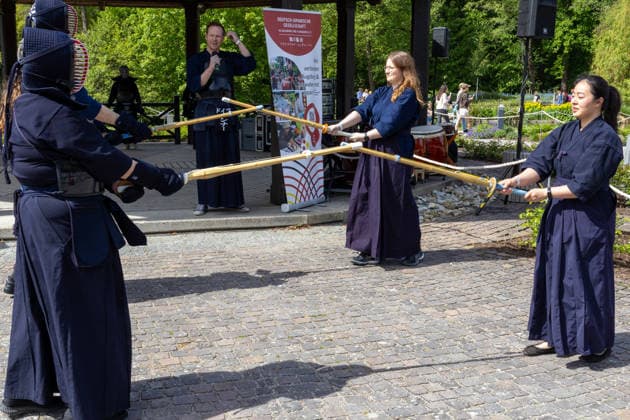 Augsburg, Bavaria, Germany May 10, 2026: Participants in Japanese-inspired costumes and kendo gear demonstrate sword fighting and role-playing. Traditional Japanese Spring Festival at the Augsburg Botanical Garden. The event is part of the garden™s 90th anniversary celebrations