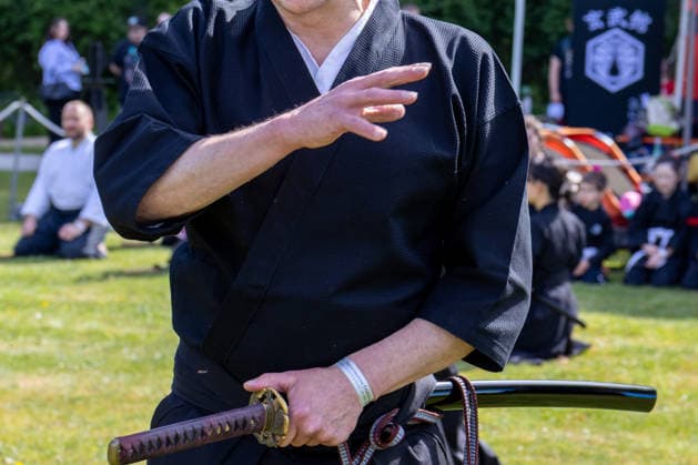 Augsburg, Bavaria, Germany May 10, 2026: A participant in a Japanese martial arts demonstration holds a katana during a display of traditional sword techniques. Traditional Japanese Spring Festival at the Augsburg Botanical Garden. The event is part of the garden™s 90th anniversary celebrations