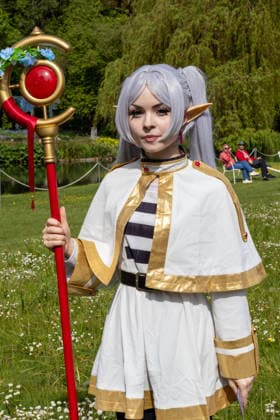 Augsburg, Bavaria, Germany May 10, 2026: A cosplayer wearing a white fantasy costume, elf ears, and an ornate wand at an outdoor event. The portrayal is based on anime, manga, and fantasy characters from the international cosplay scene. Traditional Japanese Spring Festival at the Augsburg Botanical Garden. The event is part of the garden™s 90th anniversary celebrations
