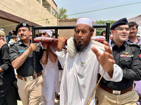 (260511) -- BANNU, May 11, 2026 -- People attend a funeral held for police personnel killed in a suicide bomb attack in Bannu district, Khyber Pakhtunkhwa province, Pakistan, on May 10, 2026. At least 15 police personnel were killed and several others injured after a suicide bomber rammed an explosive-laden vehicle into a police installation in Pakistan s northwestern Khyber Pakhtunkhwa province, official sources said on Sunday. The attack targeted the installation in Bannu district of the province at 8:55 p.m. local time on Saturday (1555 GMT), causing massive destruction to the facility, the sources told Xinhua on condition of anonymity. (Str Xinhua) PAKISTAN-BANNU-SUICIDE ATTACK-POLICE-FUNERAL AhmadxKamal 