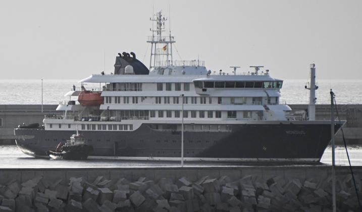 (260511) -- BEIJING, May 11, 2026 -- An inflatable boat approaches the hantavirus-hit cruise ship MV Hondius to transfer people at the Port of Granadilla on the island of Tenerife in Spain, May 10, 2026. Spanish authorities launched an operation on Sunday to evacuate and transfer all passengers and part of the crew aboard the hantavirus-hit cruise ship MV Hondius. Earlier, the vessel anchored off the Port of Granadilla on the Spanish island of Tenerife. The operation is expected to continue through Sunday and Monday. ) XINHUA PHOTOS OF THE DAY ChengxMin 