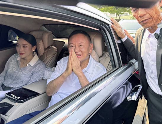 Ex-Thai PM Thaksin released from prison Former Thai Prime Minister Thaksin Shinawatra (C) gets in a car after being released from prison on parole on May 11, 2026, in Bangkok, along with his daughter, former Prime Minister Paetongtarn Shinawatra (L).  A14AA0005540659P