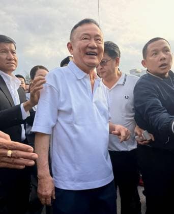 Ex-Thai PM Thaksin released from prison Former Thai Prime Minister Thaksin Shinawatra (C) is pictured on May 11, 2026, in Bangkok after being released from prison on parole.  A14AA0005540660P