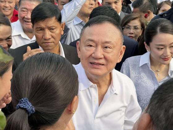Ex-Thai PM Thaksin released from prison Former Thai Prime Minister Thaksin Shinawatra (C) is pictured on May 11, 2026, in Bangkok after being released from prison on parole.  A14AA0005540661P