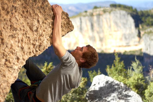 Rock, climbing and man with nature, exercise and fresh air with endurance, mountains and freedom with workout, sky and wellness. Person, athlete or guy with fitness, travel or environment with health. (License=RF) ,model released, Symbolfoto Copyright: xZoonar.com YurixArcursx 21178993 ,model released, Symbolfoto ,property released