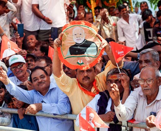 A man in the crowd holds an embroidered portrait of Prime Minister Narendra Modi during his roadshow on the occasion of Somnath Amrut Mahotsav Gir Somnath, May 11 (ANI): A man in the crowd holds an embroidered portrait of Prime Minister Narendra Modi during his roadshow on the occasion of Somnath Amrut Mahotsav, celebrating 75 years of the inauguration of the restored Somnath temple, in Gir Somnath on Monday. (DPR PMO ANI Photo) Gir Somnath Gujarat India Copyright: xANIx ANI_20260511148