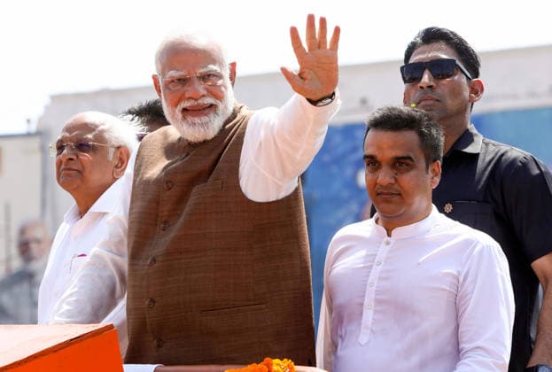 Prime Minister Narendra Modi waves to the crowd during a roadshow on the occasion of Somnath Amrut Mahotsav Gir Somnath, May 11 (ANI): Prime Minister Narendra Modi waves to the crowd during a roadshow on the occasion of Somnath Amrut Mahotsav, celebrating 75 years of the inauguration of the restored Somnath temple, in Gir Somnath on Monday. Gujarat Chief Minister Bhupendra Patel and Deputy Chief Minister Harsh Sanghavi also present. Gir Somnath Gujarat India Copyright: xANIx ANI_20260511185