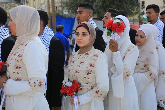 Mass wedding held for Palestinian couples in Gaza City Palestinians take part in a mass wedding ceremony for Palestinian brides and grooms organized by the Turkish Humanitarian Relief Foundation (IHH) in Gaza City on May 11, 2026. The mass wedding was held as part of a humanitarian initiative aimed at supporting 50 grooms who are sons of Palestinians killed during the war, amid difficult humanitarian and economic conditions in the Gaza Strip. Photo by Bilal Osama apaimages Gaza city Gaza Strip Palestinian Territory 110526_Gaza_BO_02(27) Copyright: xapaimagesxBilalxOsamax xapaimagesx