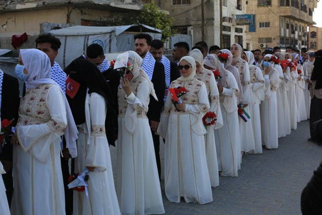 Mass wedding held for Palestinian couples in Gaza City Palestinians take part in a mass wedding ceremony for Palestinian brides and grooms organized by the Turkish Humanitarian Relief Foundation (IHH) in Gaza City on May 11, 2026. The mass wedding was held as part of a humanitarian initiative aimed at supporting 50 grooms who are sons of Palestinians killed during the war, amid difficult humanitarian and economic conditions in the Gaza Strip. Photo by Bilal Osama apaimages Gaza city Gaza Strip Palestinian Territory 110526_Gaza_BO_02(28) Copyright: xapaimagesxBilalxOsamax xapaimagesx