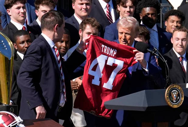 Donald Trump hosts Indiana University Football Champions - Washington Indiana University head football Coach Curt Cignetti gives US President Donald Trump a team jersey as they take part in an event honoring the 2026 College National Football Champions, Indiana University to the White House during a ceremony on the south lawn on May 11, 2026 in Washington, DC. Photo by Yuri Gripas ABACAPRESS.COM Washington DC United States  Copyright: xPool ABACAx