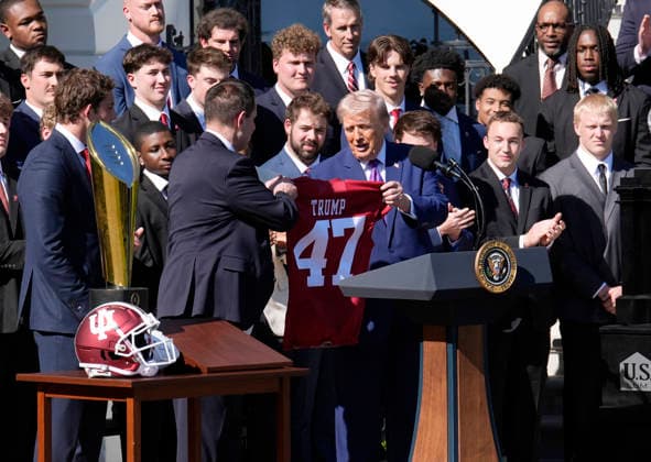 Donald Trump hosts Indiana University Football Champions - Washington Indiana University head football Coach Curt Cignetti gives US President Donald Trump a team jersey as they take part in an event honoring the 2026 College National Football Champions, Indiana University to the White House during a ceremony on the south lawn on May 11, 2026 in Washington, DC. Photo by Yuri Gripas ABACAPRESS.COM Washington DC United States  Copyright: xPool ABACAx