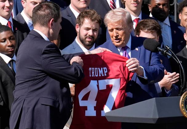 Donald Trump hosts Indiana University Football Champions - Washington Indiana University head football Coach Curt Cignetti gives US President Donald Trump a team jersey as they take part in an event honoring the 2026 College National Football Champions, Indiana University to the White House during a ceremony on the south lawn on May 11, 2026 in Washington, DC. Photo by Yuri Gripas ABACAPRESS.COM Washington DC United States  Copyright: xPool ABACAx