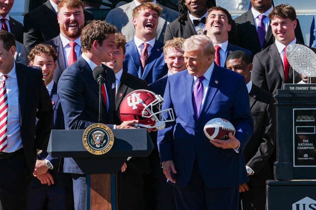 DC: President Trump hosts 2026 National Football Champions Indiana University Indiana wide receiver Charlie Becker gives President Donald Trump a football helmet during an event hosting the 2026 National Football Champions Indiana University on the South Lawn of The White House in Washington D.C., on Monday, May 11, 2026. (Photo by Aaron Schwartz Pool ABACAPRESS.COM) Washington District of Columbia United States  Copyright: xPool ABACAx