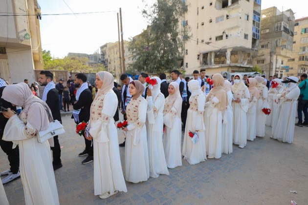 Mass Wedding Gaza City May 11 Brides wearing white dresses and grooms wearing suits and keffiyehs stand in line during a mass wedding celebration in Gaza City, Gaza Strip, on May 11, 2026. The mass wedding celebration for 50 grooms, identified by organizers as orphans of conflict casualties, is sponsored by the Turkish Humanitarian Relief Foundation (IHH). Gaza Gaza Strip Palestinian Territories Copyright: xAhmedxAlxArinix