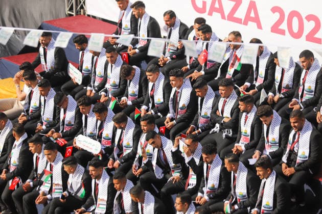 Mass Wedding Gaza City May 11 Grooms sit on the steps of a stage beneath a banner reading Gaza Wedding Project, during a mass wedding celebration in Gaza City, Gaza Strip, on May 11, 2026. The mass wedding celebration for 50 grooms, identified by organizers as orphans of conflict casualties, is sponsored by the Turkish Humanitarian Relief Foundation (IHH). Gaza Gaza Strip Palestinian Territories Copyright: xAhmedxAlxArinix
