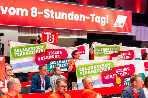 Protest at DGB EUR, Germany, Berlin, 12 05 2026 Delegates protest during the Federal Chancellors speech at the 23 DGB Federal Congress Proud to be a Union Member slogan , demand to preserve the 8-hour day, hands off