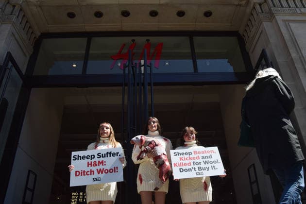 May 12, 2026, London, England, United Kingdom: PETA activists with fake bruises and blood hold a fake dead lamb during a protest outside H&M on Regent Street, calling on the fashion group to stop selling wool. London United Kingdom  - ZUMAv130 20260512_zip_v130_007 Copyright: xVukxValcicx