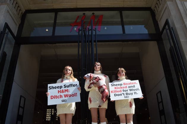 May 12, 2026, London, England, United Kingdom: PETA activists with fake bruises and blood hold a fake dead lamb during a protest outside H&M on Regent Street, calling on the fashion group to stop selling wool. London United Kingdom - ZUMAv130 20260512_zip_v130_006 Copyright: xVukxValcicx