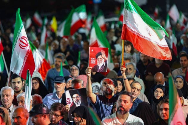 May 12, 2026, Iran, Iran: A Pro-government supporter holds a picture of the late Supreme Leader Ayatollah Ali Khamenei during a state-organized rally, amid a ceasefire in the conflict involving Iran, the United States, and Israel. The United States and Israel launched strikes against Iran on February 28, killing IranÃ¢â‚¬â ¢s supreme leader and top military leaders, prompting Iranian authorities to retaliate with strikes on Israel and across the Gulf, while U.S. President Donald Trump recently described the ceasefire agreement with Iran as being in a Ã¢â‚¬oevery weakÃ¢â‚¬Â state and the spokesman for the Iranian parliamentÃ¢â‚¬â ¢s national security commission warned the United States on May 10 against any attacks on vessels in Gulf waters - ZUMAi98_ 20260512_zih_i98_010 Copyright: xIranianxSupremexLeader SxOfficex