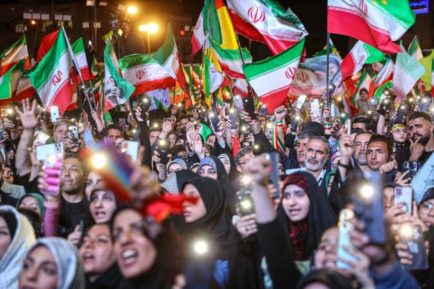 May 12, 2026, Tehran, Iran: Pro-government supporters wave national flags during a state-organized rally, amid a ceasefire in the conflict involving Iran, the United States, and Israel. The United States and Israel launched strikes against Iran on February 28, killing Iranâ€⠢s supreme leader and top military leaders, prompting Iranian authorities to retaliate with strikes on Israel and across the Gulf, while U.S. President Donald Trump recently described the ceasefire agreement with Iran as being in a â€oevery weak†state and the spokesman for the Iranian parliamentâ€⠢s national security commission warned the United States on May 10 against any attacks on vessels in Gulf waters, saying Iranâ€⠢s restraint was over. T - ZUMAi98_ 20260512_zih_i98_015 Copyright: xIranianxSupremexLeader SxOfficex