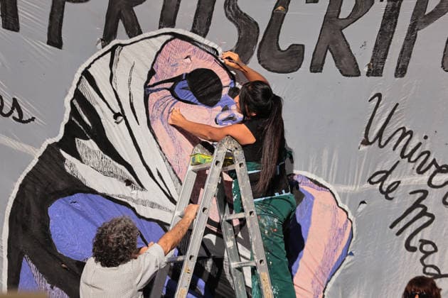Nationwide march in defense of public university held in Buenos Aires BUENOS AIRES, ARGENTINA - MAY 12: A woman paints a mural on a wall as demonstrators carrying banners, flags, and signs demanding higher education funding and salary increases for professors and researchers march toward Plaza de Mayo during a nationwide demonstration, in Buenos Aires, Argentina, on May 12, 2026. Protesters demand the implementation of the University Funding Law, oppose budget cuts introduced by the government of Argentine President Javier Milei, and advocate for the protection of Argentina’s public university system amid the country’s economic crisis and austerity measures. Luciano Gonzalez Anadolu Buenos Aires Argentina. Editorial use only. Please get i  Copyright: x2026xAnadoluxLucianoxGonzalezx