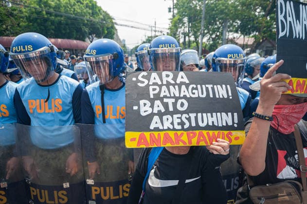 May 13, 2026, Pasay, Metro Manila, Philippines: A protester holds up a a sign calling for the arrest of Senator Dela Rosa and impeachment of Vice President Duterte in front of the riot police. Pasay Philippines - ZUMAy102 20260513_zip_y102_008 Copyright: xKenosisxYapx