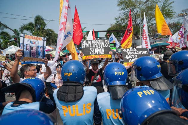 May 13, 2026, Pasay, Metro Manila, Philippines: Protesters stand in front of riot police as they approach the gates of the Philippine Senate. Pasay Philippines - ZUMAy102 20260513_zip_y102_011 Copyright: xKenosisxYapx