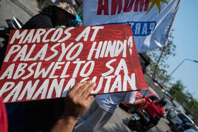 May 13, 2026, Pasay, Metro Manila, Philippines: A protester carries a sign calling out the president. Pasay Philippines - ZUMAy102 20260513_zip_y102_025 Copyright: xKenosisxYapx
