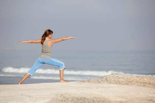Beautiful young woman with arms open, relaxing on the beach model released Symbolfoto Copyright: xIkox Panthermedia67994432.jpg